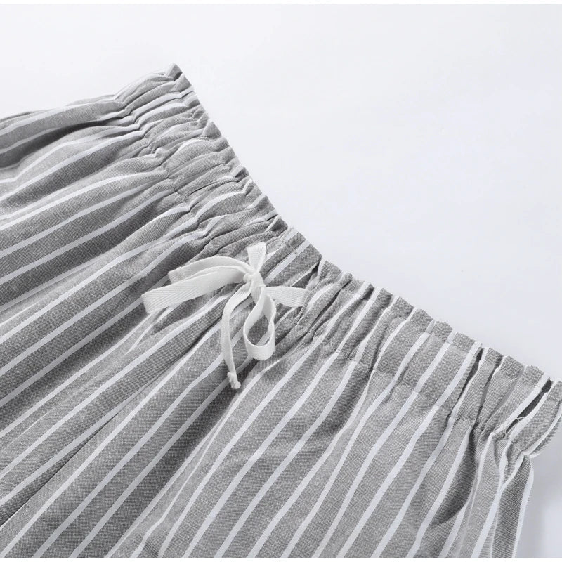 Gray striped pants with drawstring on a light gray background