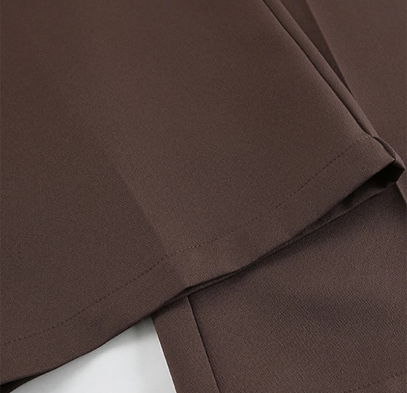 Close-up of brown fabric with a visible seam on a white background