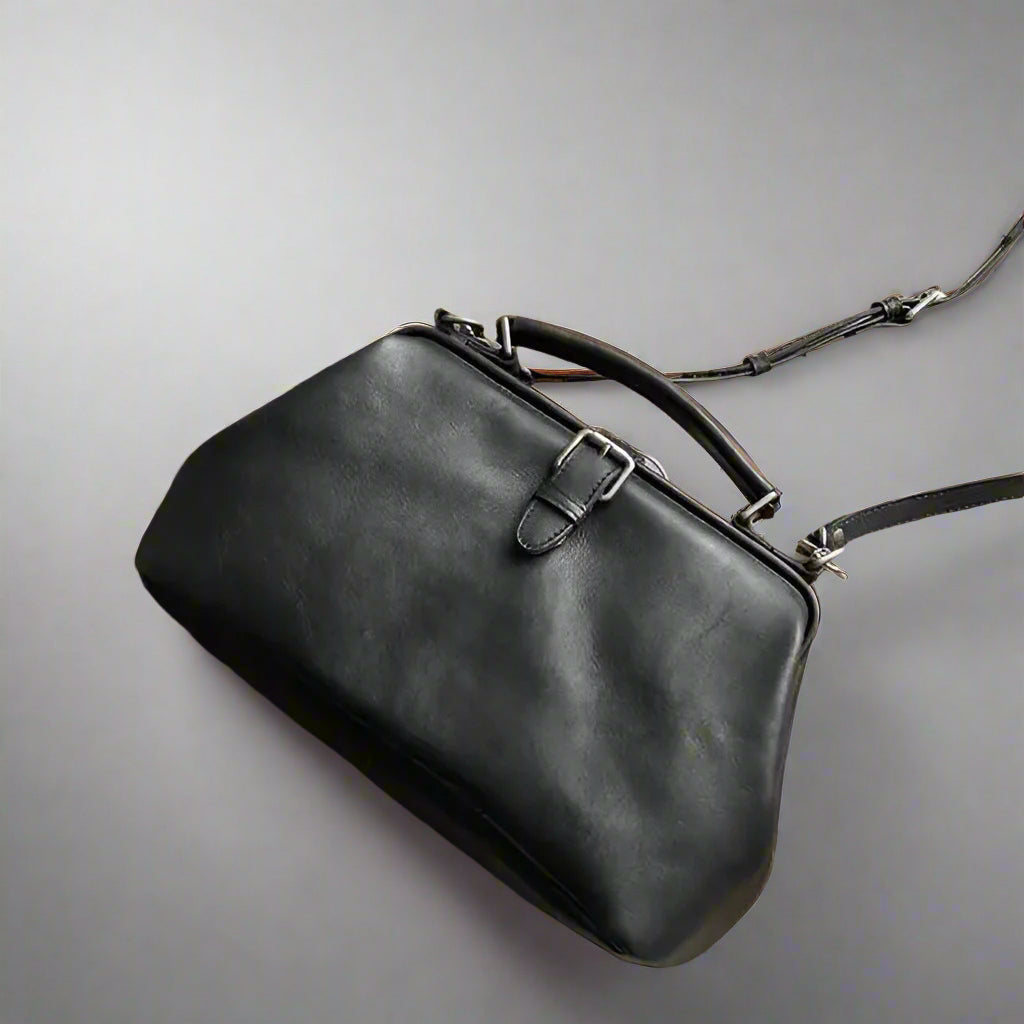Black leather handbag on a light background
