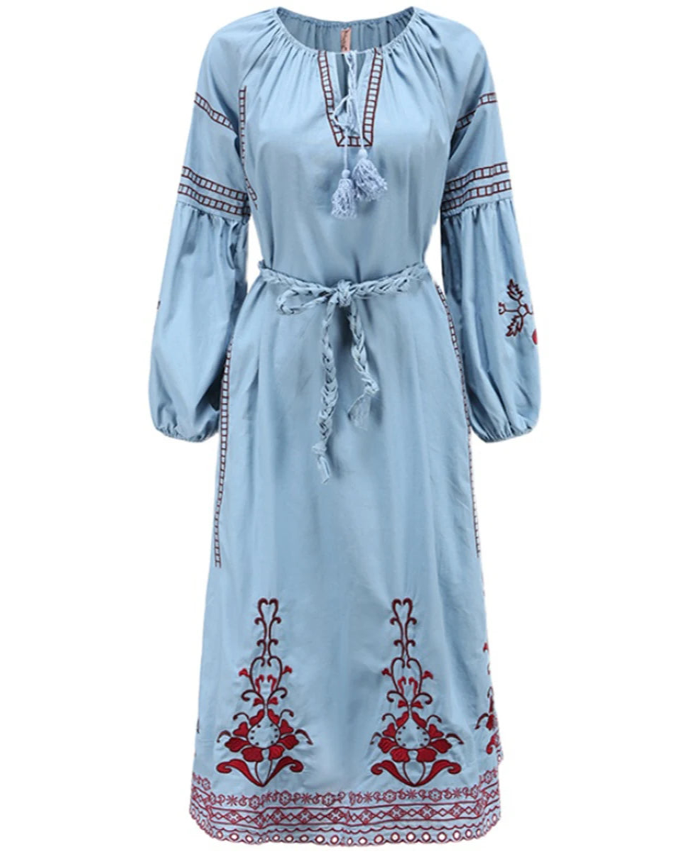 Light blue dress with red and white embroidery on a white background