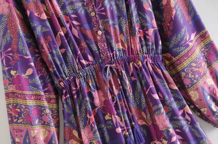 Close-up of a purple patterned dress with a white background
