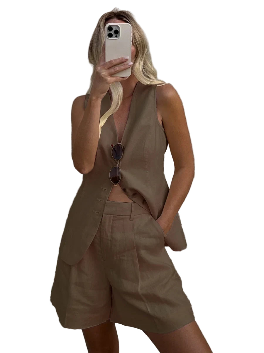 Person wearing a beige sleeveless blazer and shorts against a plain background