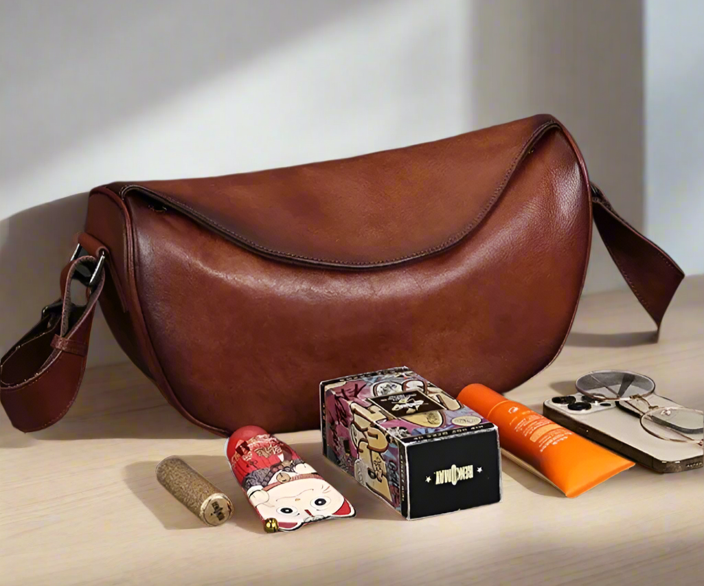 Brown leather bag on a wooden table