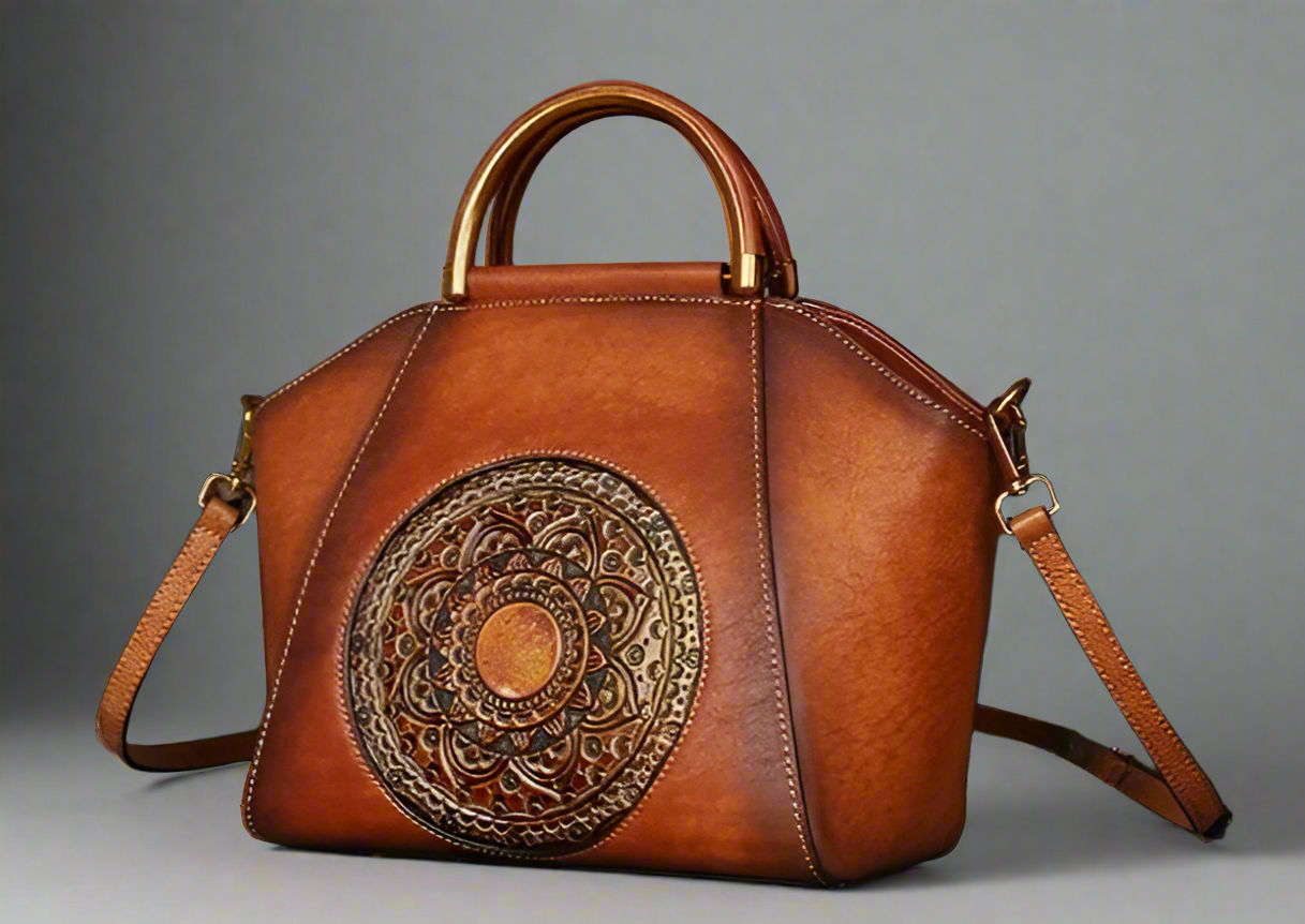 Brown leather handbag with intricate design on a light background