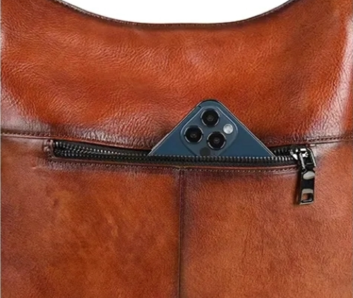 Brown leather bag with zipper on a white background