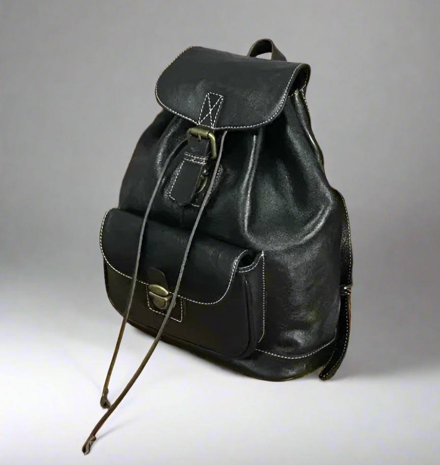Black leather backpack on a gray background