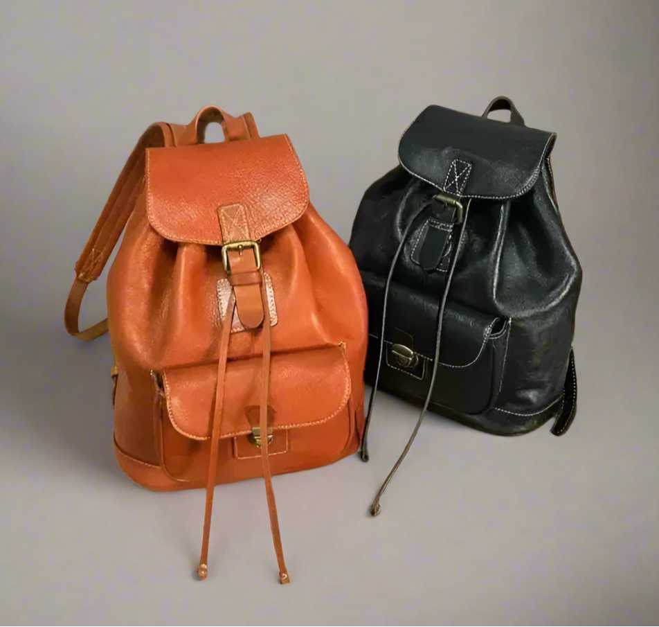Two backpacks, one brown and one black, on a light background.