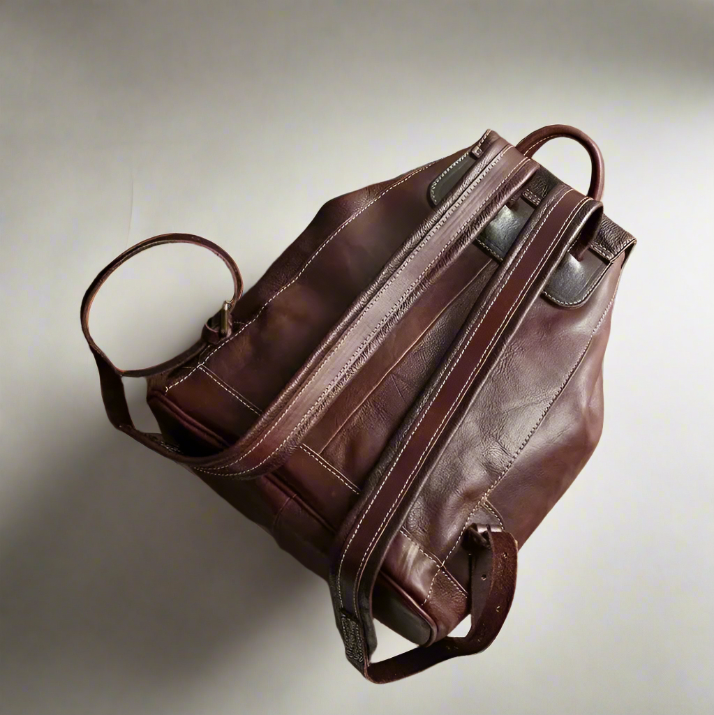 Brown leather bag on a light background