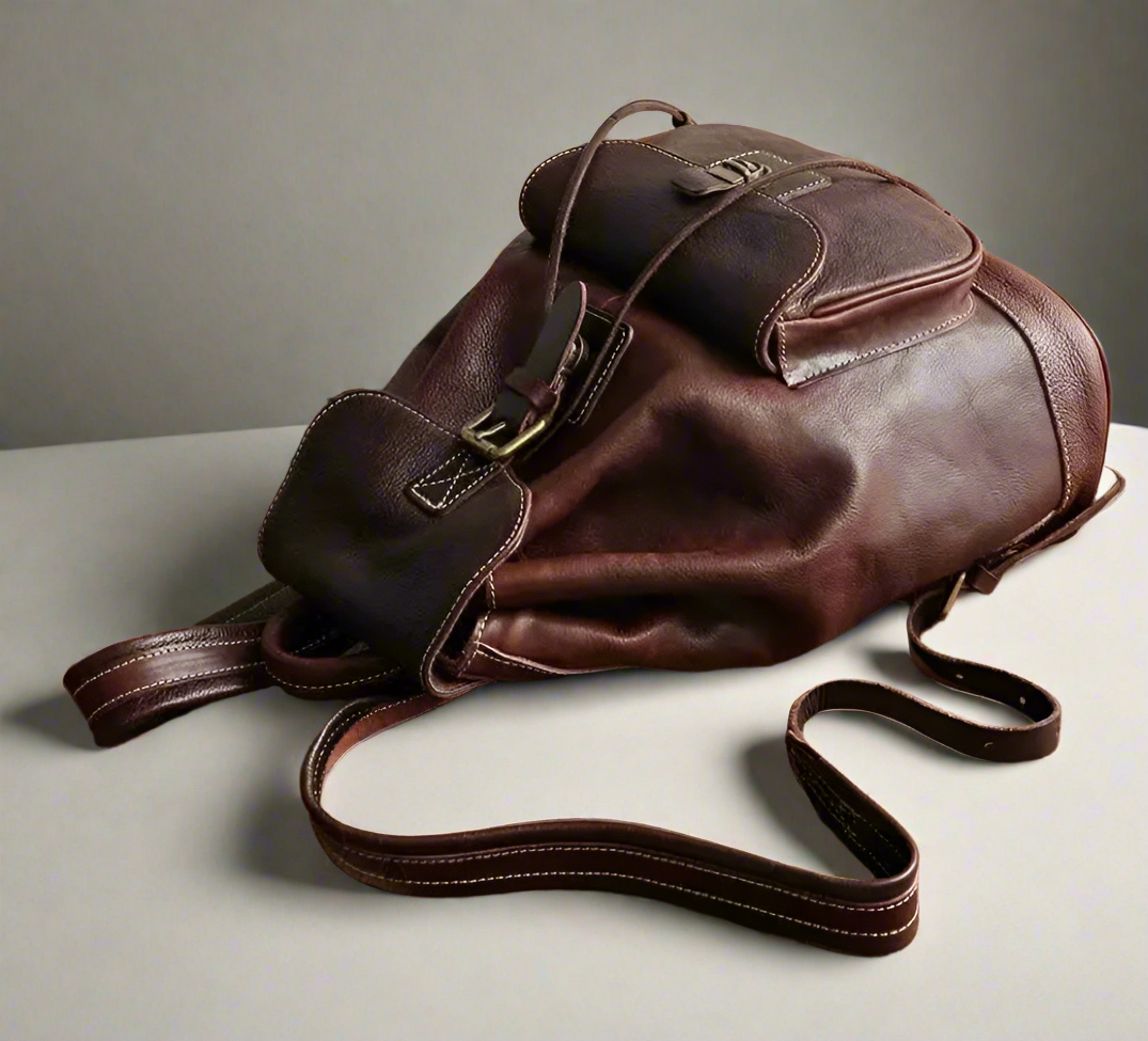 Brown leather backpack on a white background