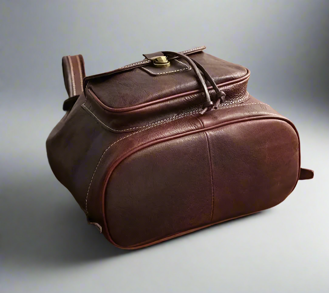 Brown leather bag on a white surface