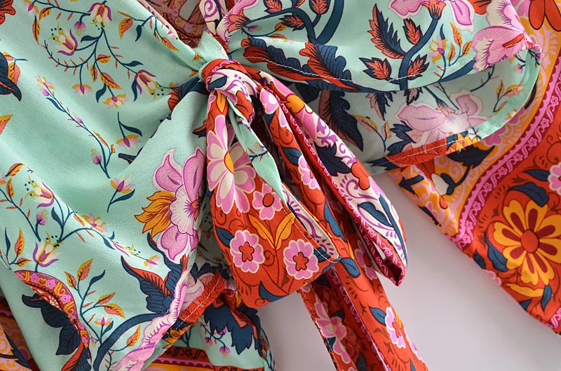 Close-up of colorful floral fabric with a knot on a light background