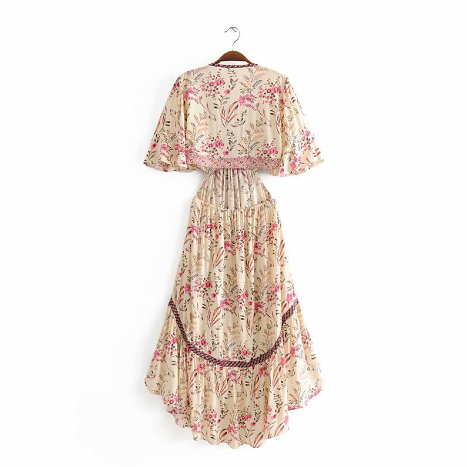 Floral dress on a hanger against a white background