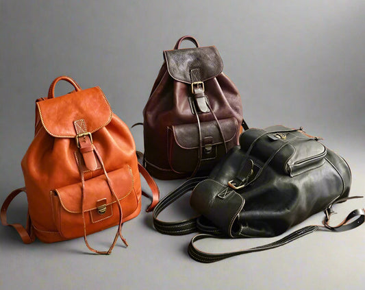 Three leather backpacks in brown, black on a light background