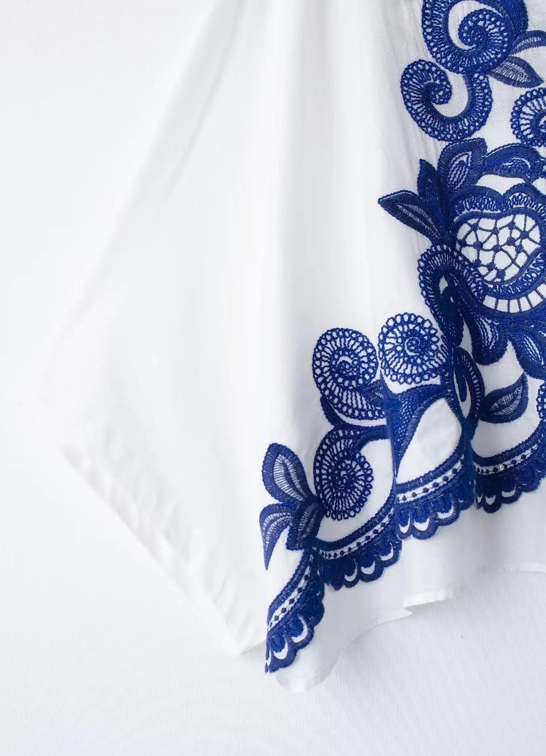 Blue lace trim on a white fabric background