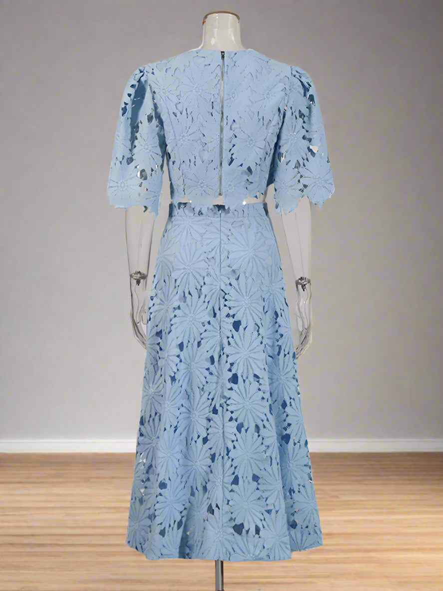 Light blue lace dress on a mannequin against a white background