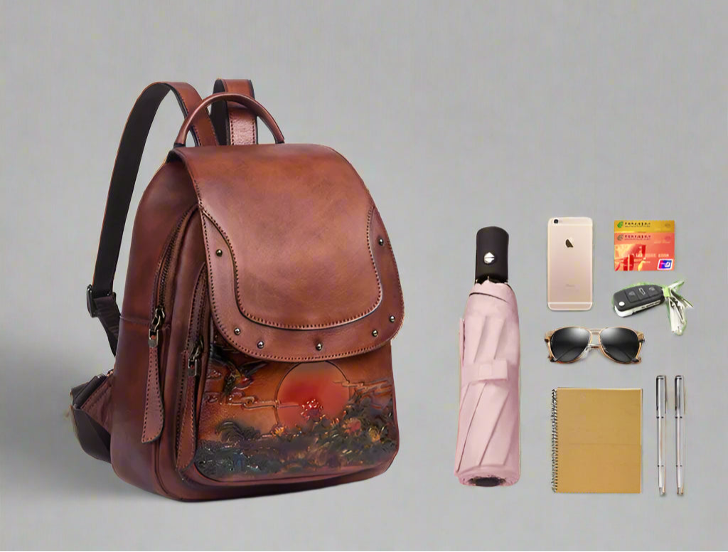 Brown leather backpack with travel items on a white background