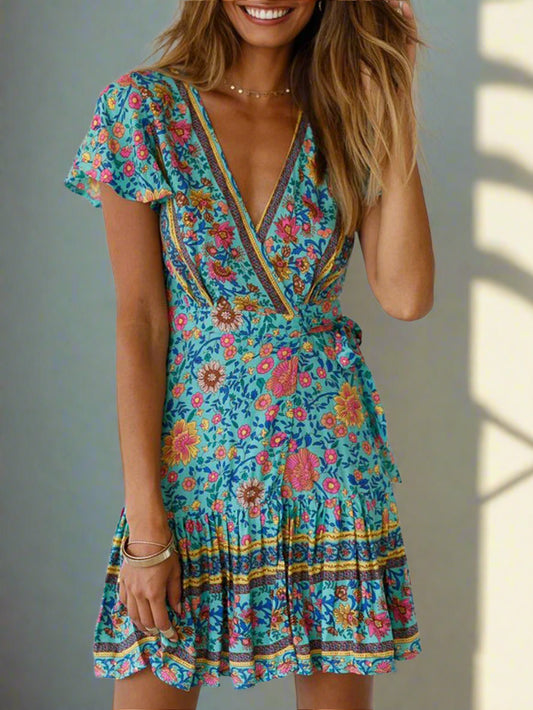 Woman wearing a colorful floral dress against a white background
