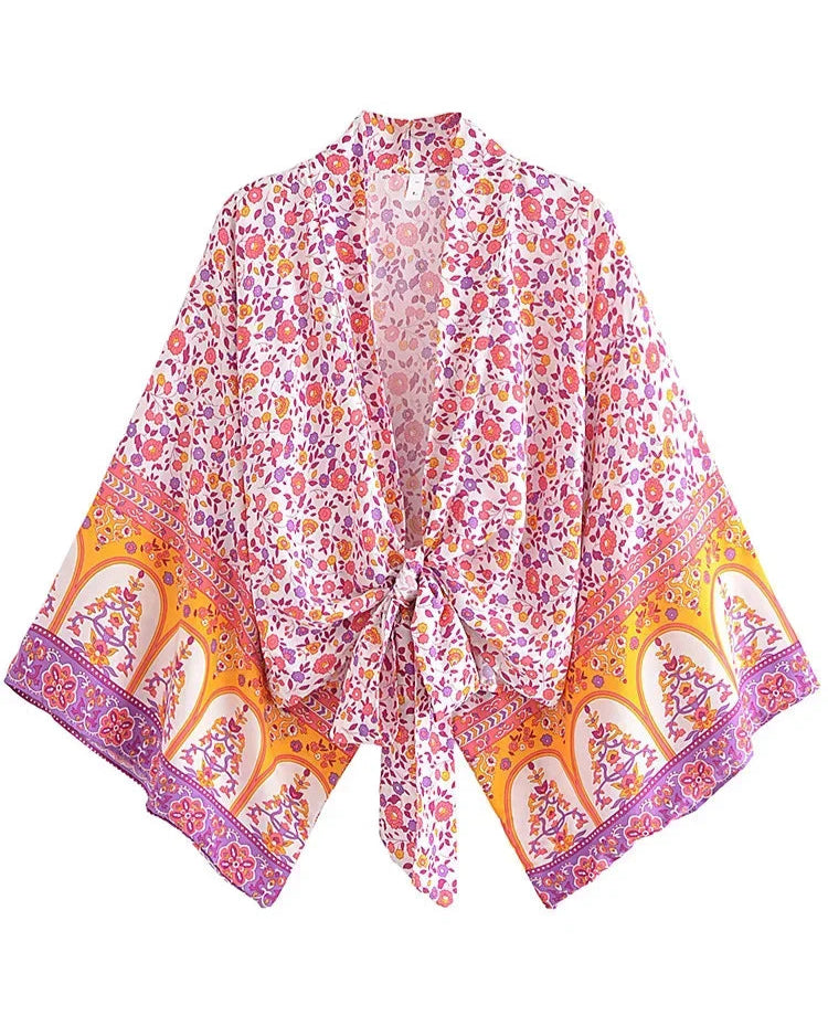 Colorful floral and abstract patterned scarf on a white background