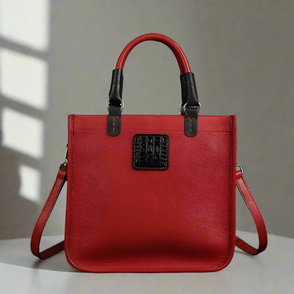Red handbag with black accents on a white background