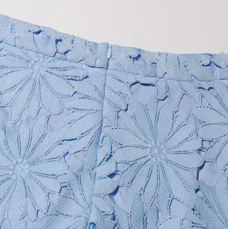 Close-up of blue floral patterned fabric on a white background