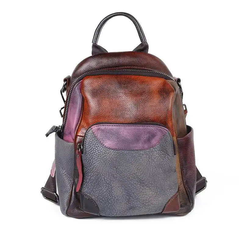 Multicolored backpack with brown, gray, and purple sections on a white background