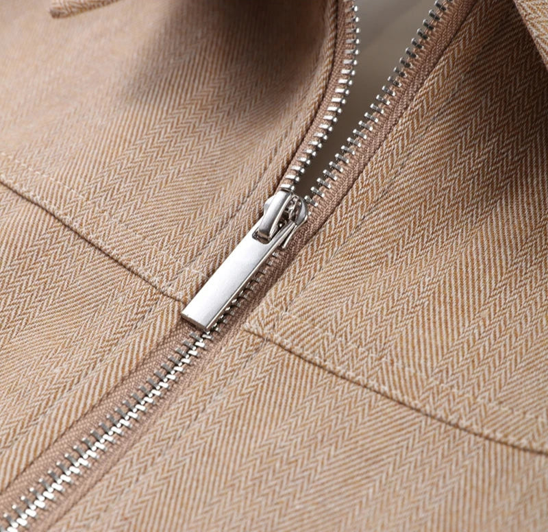 Close-up of a beige jacket with a zipper
