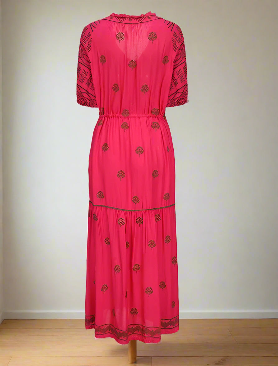 Pink dress with black floral patterns on a white background