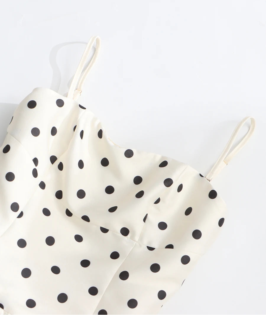 White satin camisole with black polka dots on a white background