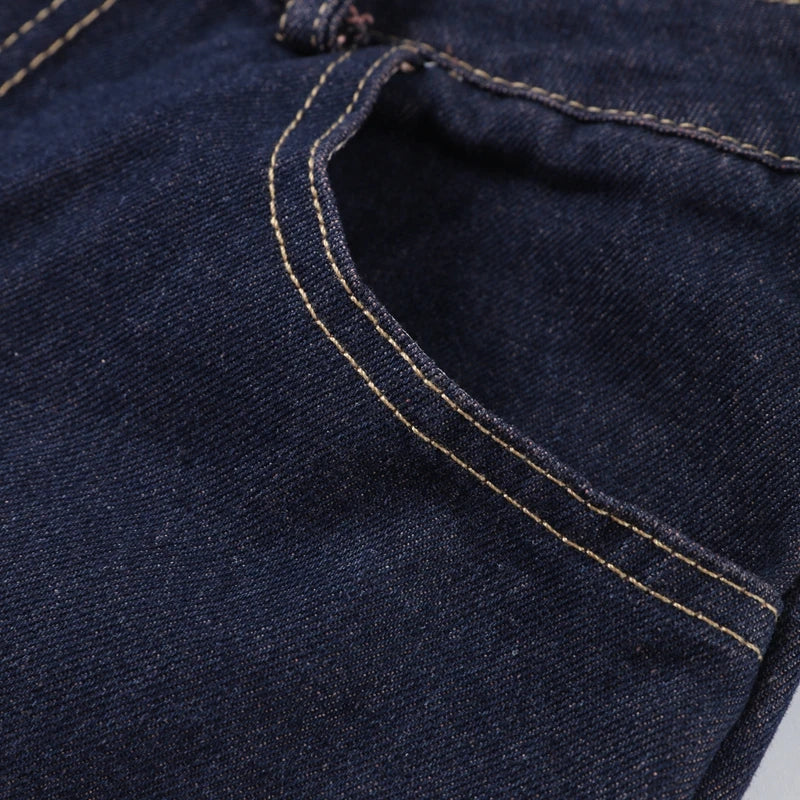 Close-up of dark blue denim fabric with stitching detail