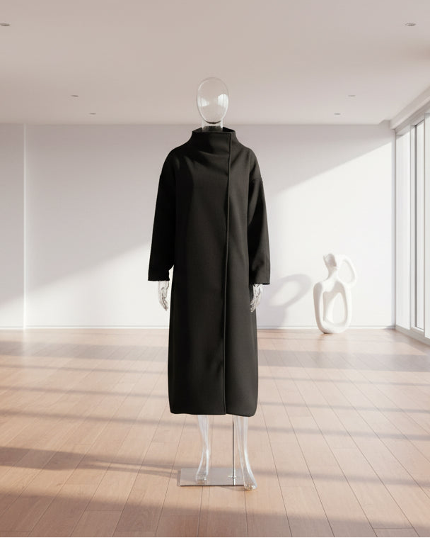 Black coat on a mannequin against a white wall 