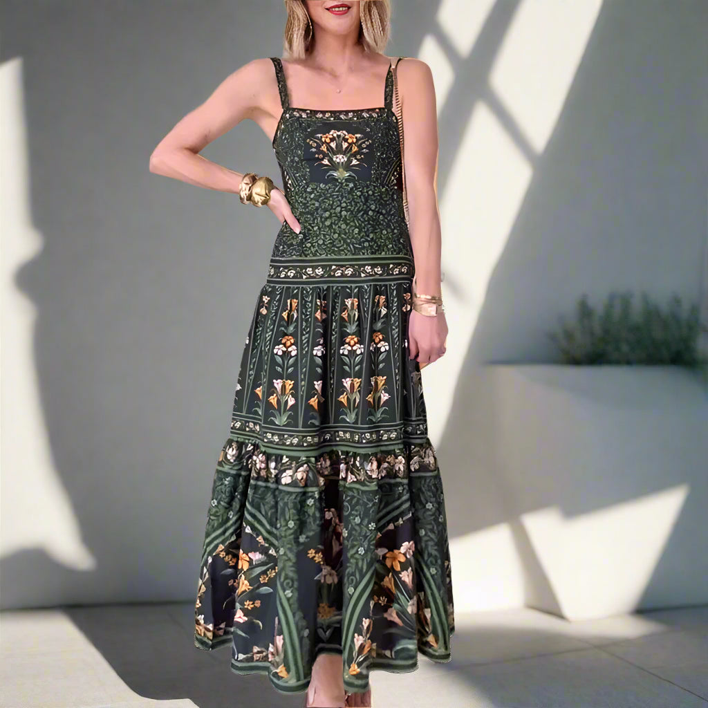 Woman wearing a green patterned dress in a room with white walls and tiled floor.