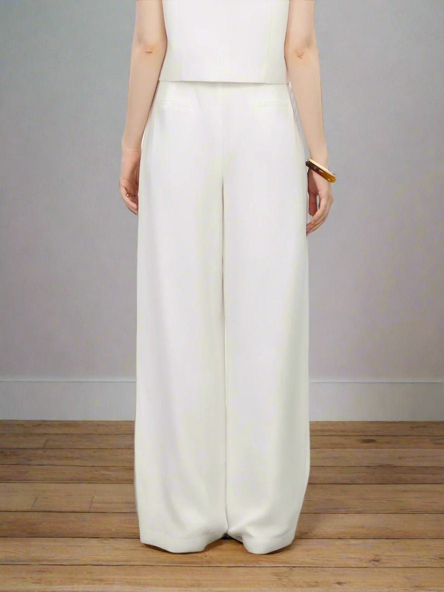 White wide-leg pants worn by a person on a plain background