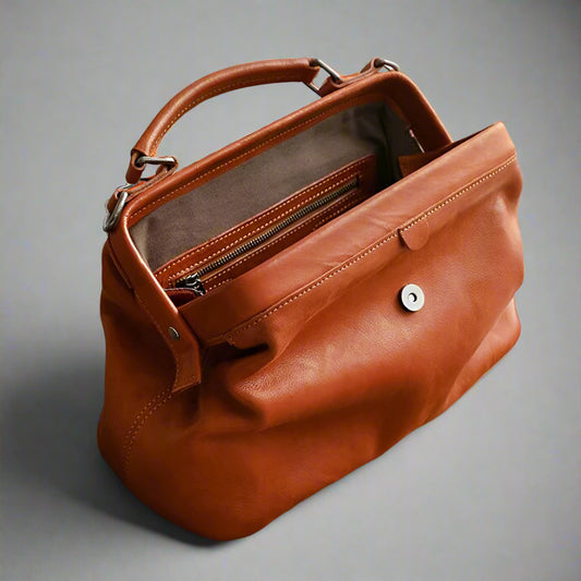 Brown leather handbag on a white background
