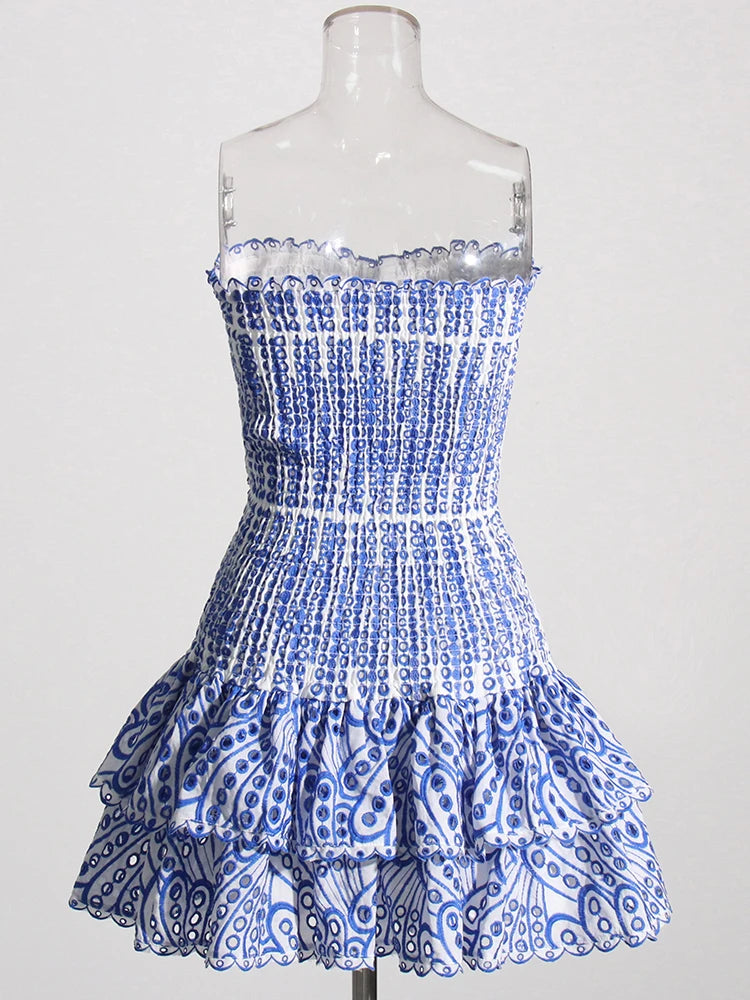 Blue and white patterned dress on a mannequin against a white background