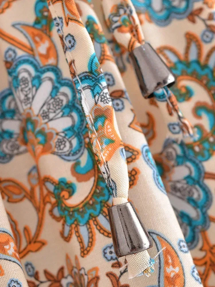 Close-up of a patterned fabric with decorative elements and metal clasps.