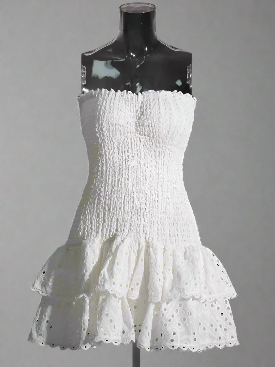 White strapless dress with ruffled layers on a mannequin against a plain background