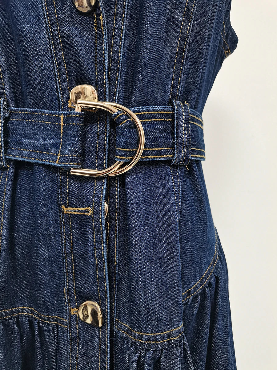 Close-up of a blue denim dress with a belt and gold buckle on a white background