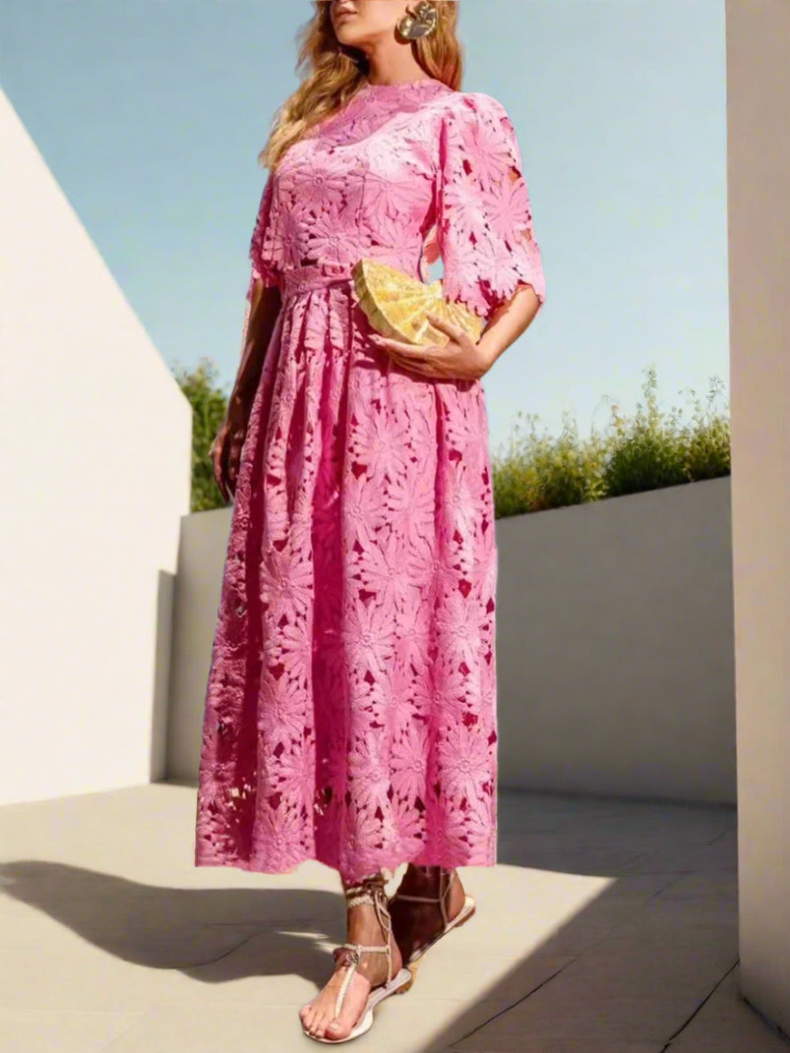 Woman in a pink outfit set standing on a backyard garden, sunny