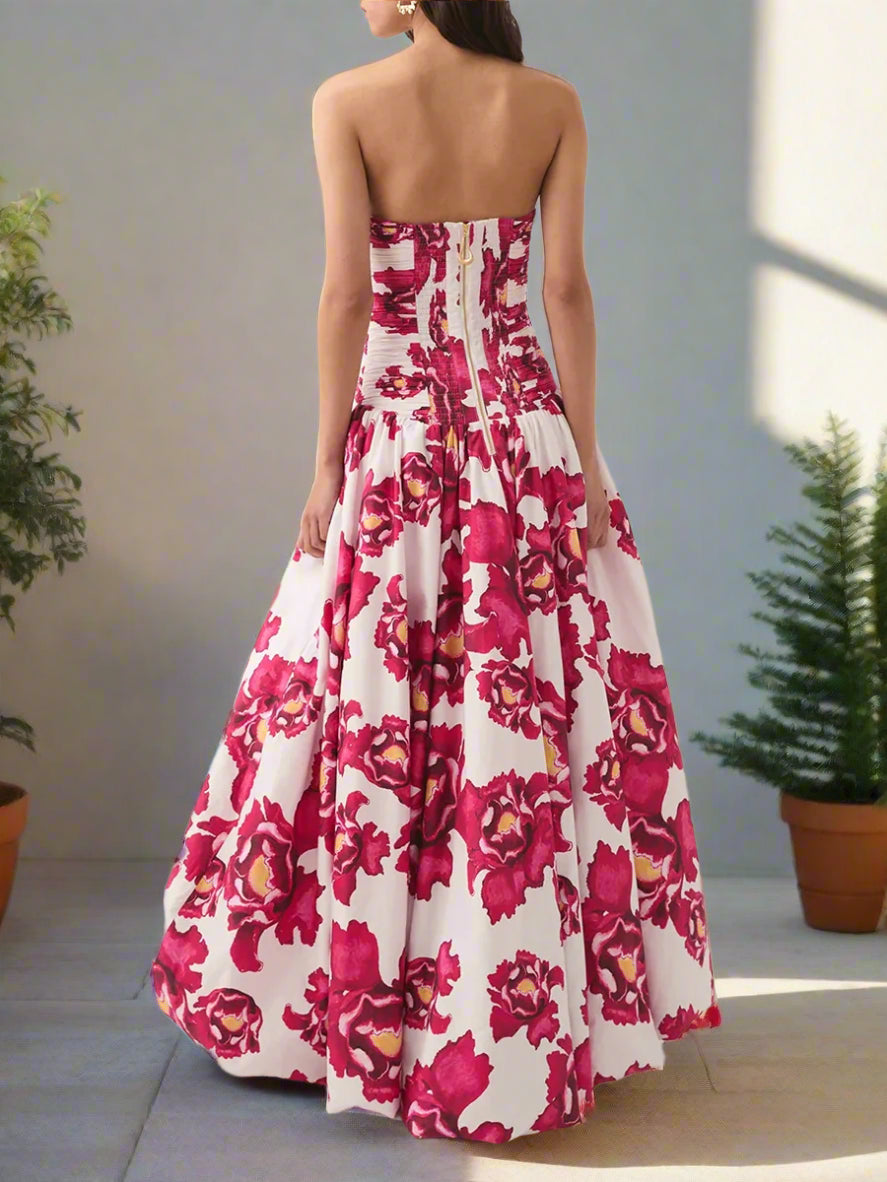 Woman wearing a strapless floral dress with pink and white flowers on a backyard garden, sunny day