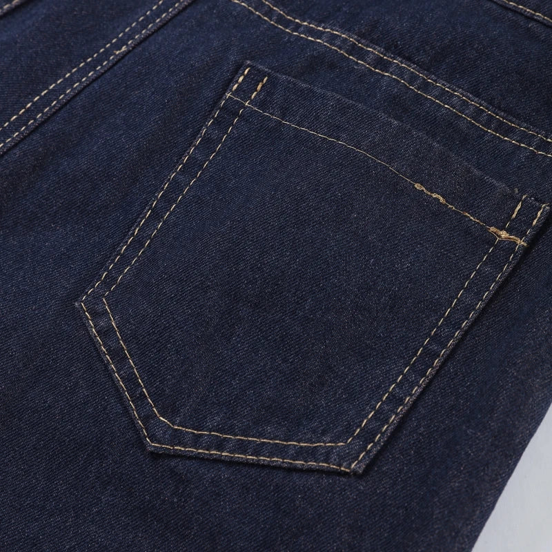 Close-up of a blue denim pocket with stitching detail