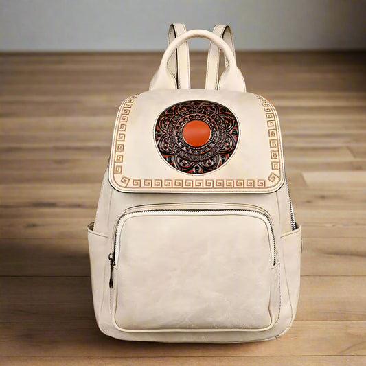 White backpack with decorative element on a wooden surface