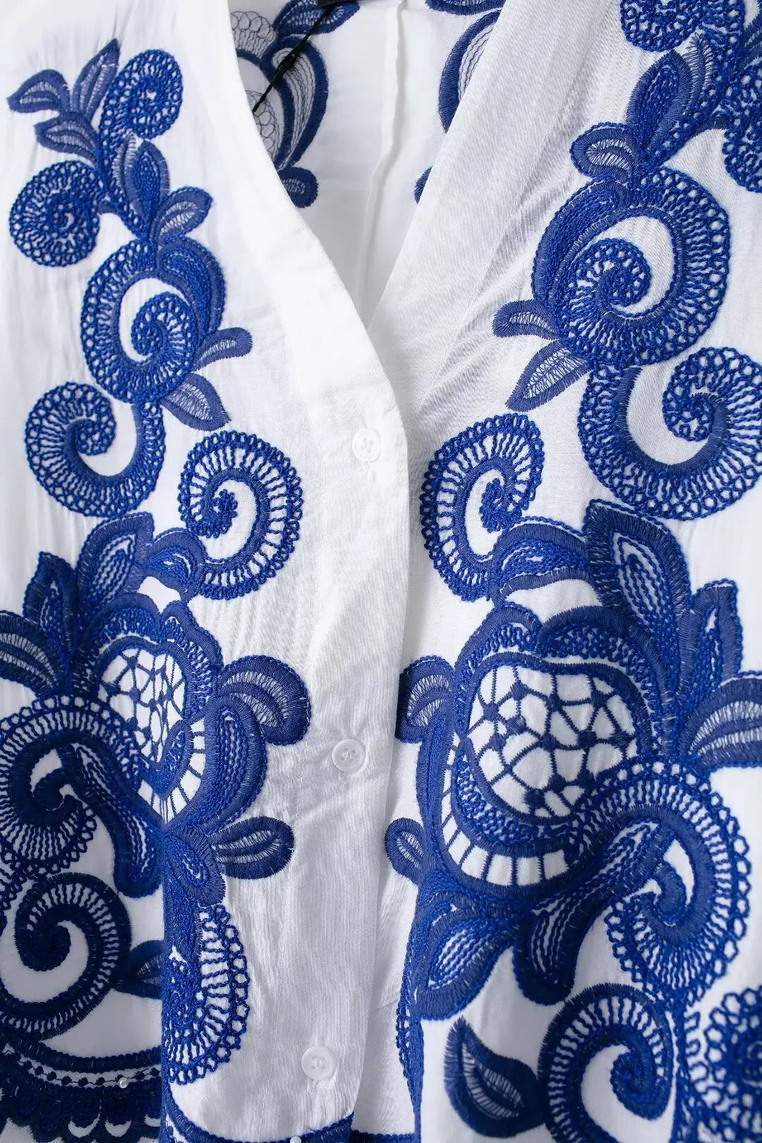 White fabric with blue intricate patterns