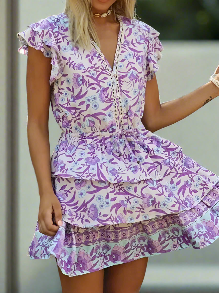 Woman wearing a purple floral dress with a blurred background