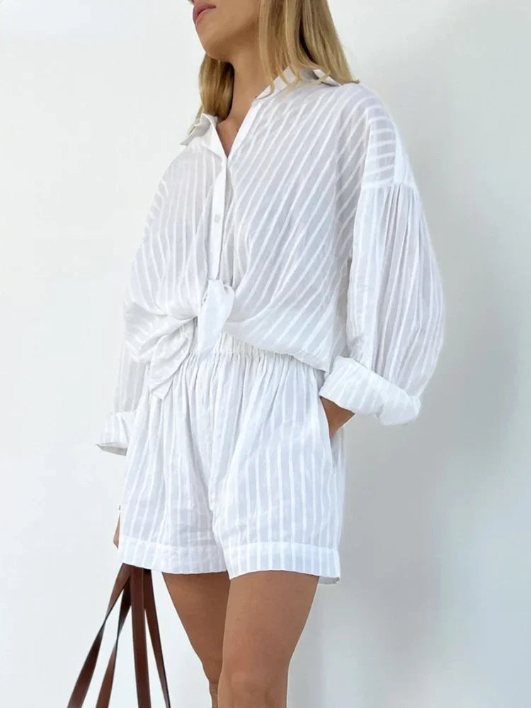 White striped romper worn by a person on a plain background
