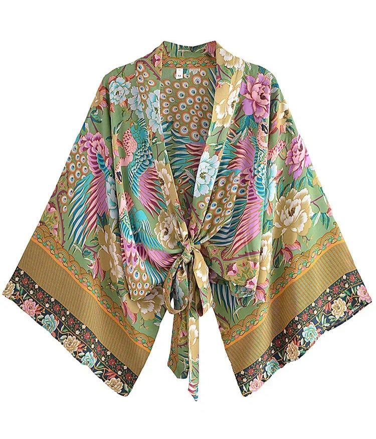 Colorful floral and bird patterned kimono on a white background