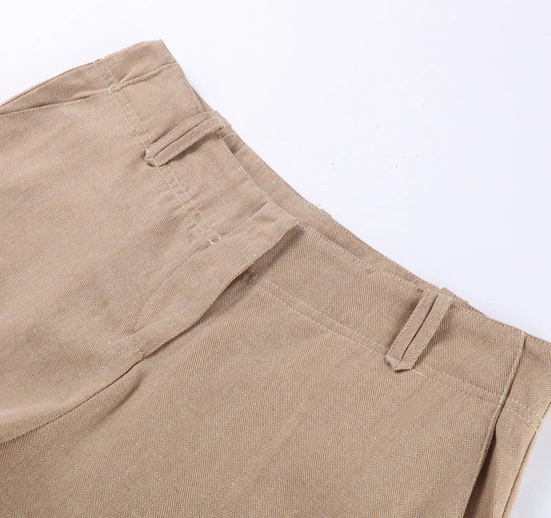 Close-up of beige pants with a plain background