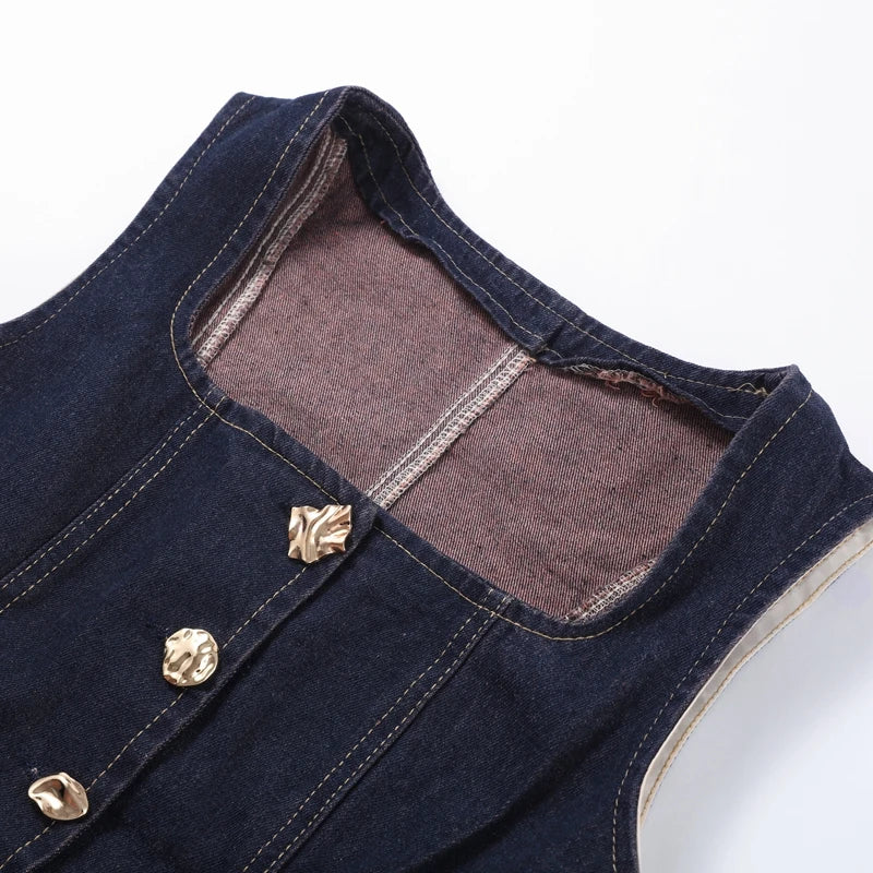 Close-up of a denim vest with gold buttons on a white background