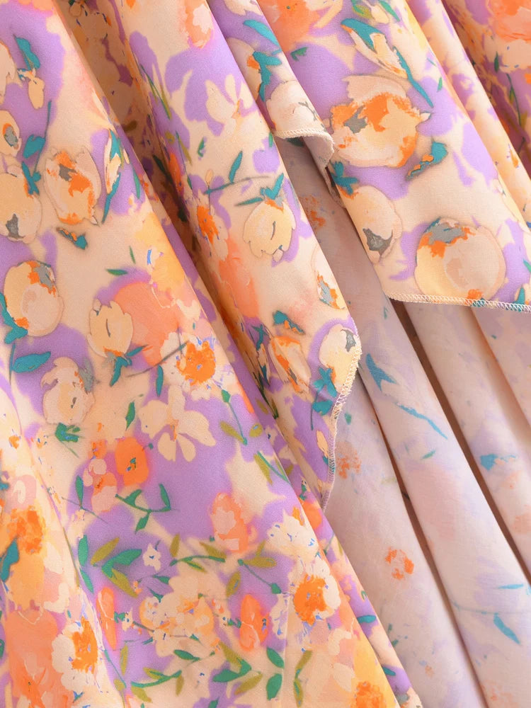 Fabric with floral pattern featuring orange flowers and green leaves on a light background