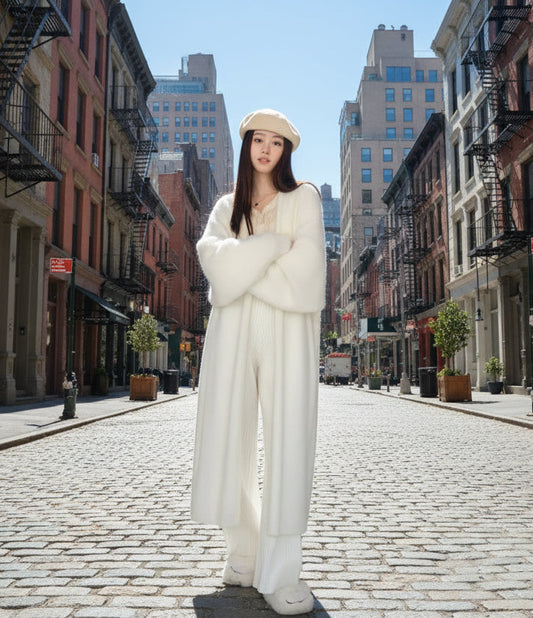 A woman wearing a long pink knitted cardigan with long sleeves