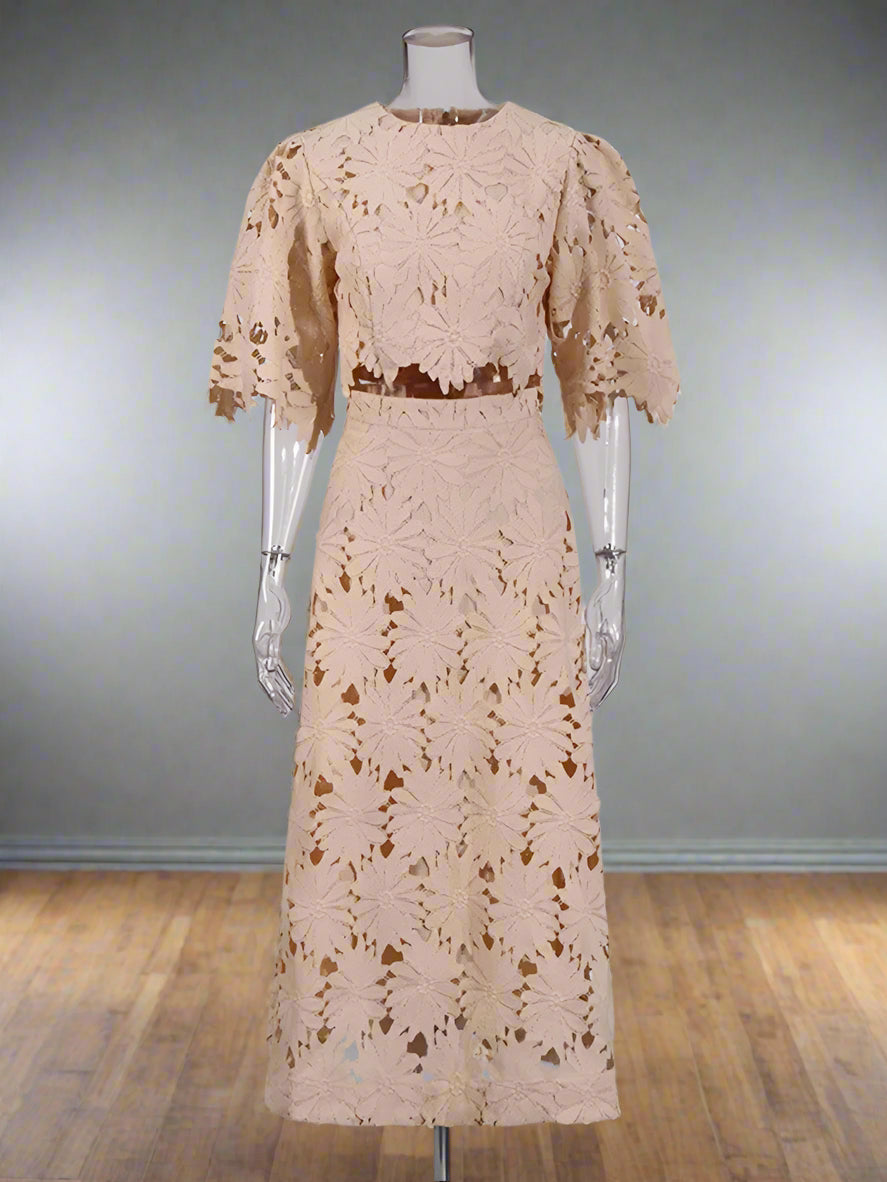 Beige lace dress on a mannequin against a white background